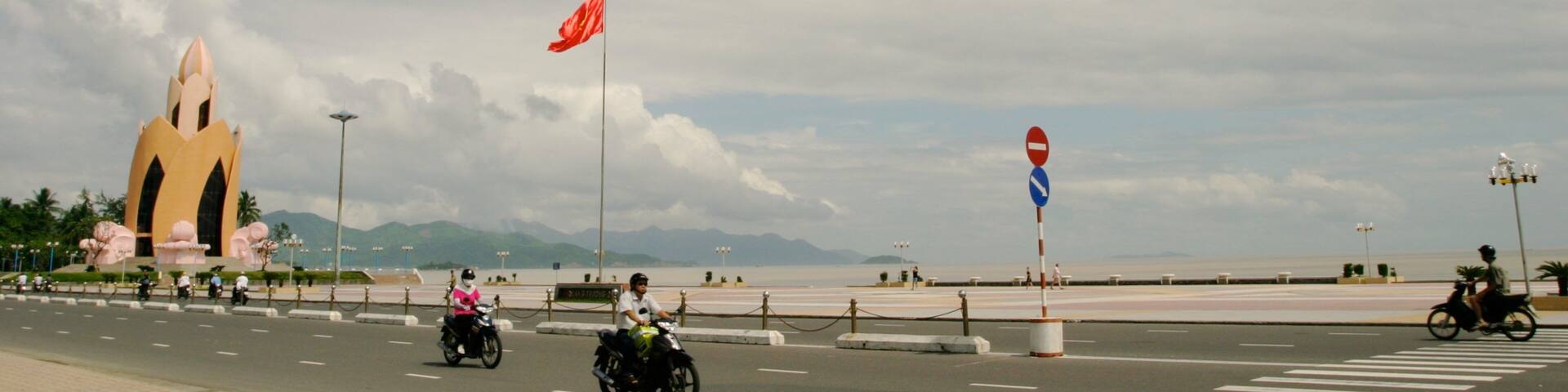 Nha Trang featuring motorbike riding, a coastal town and street scenes