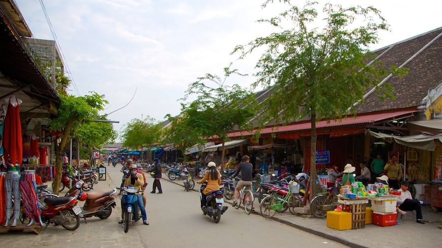 Hoi An City Centre featuring motorbike riding, street scenes and markets