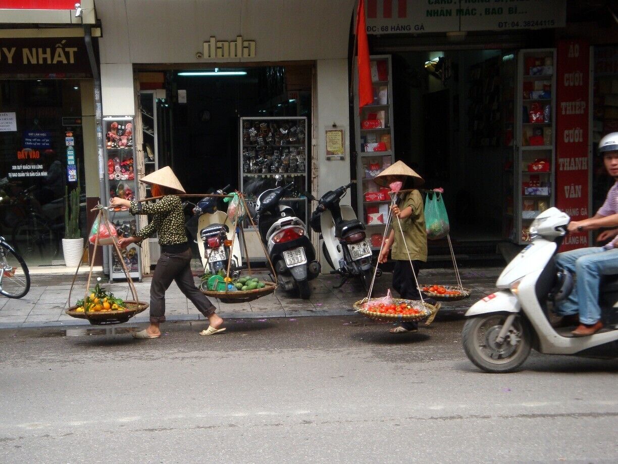 Vegetable vendors walking the streets in Hanoi