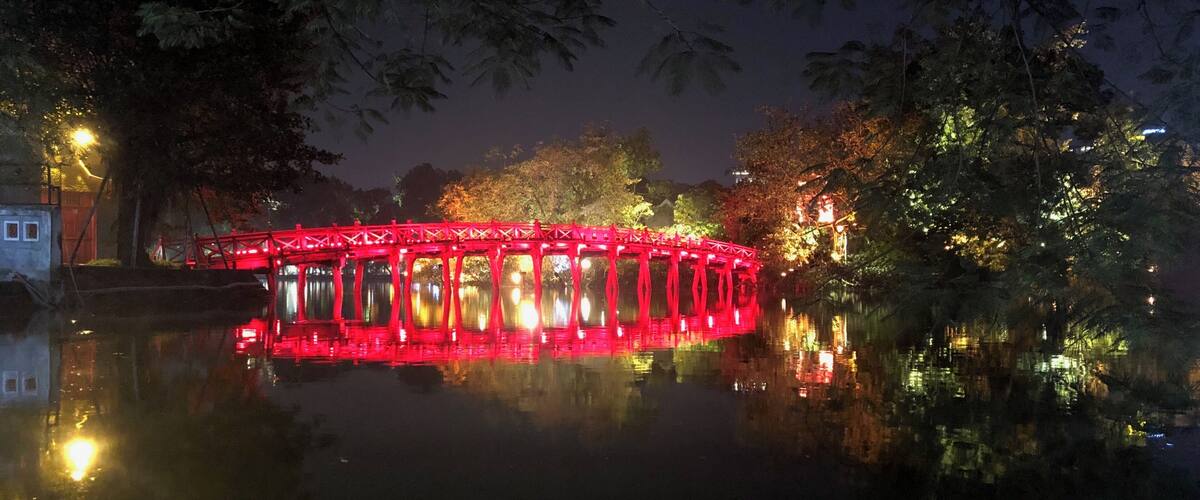 Nice reflection of the lighted up bridge with the moon behind