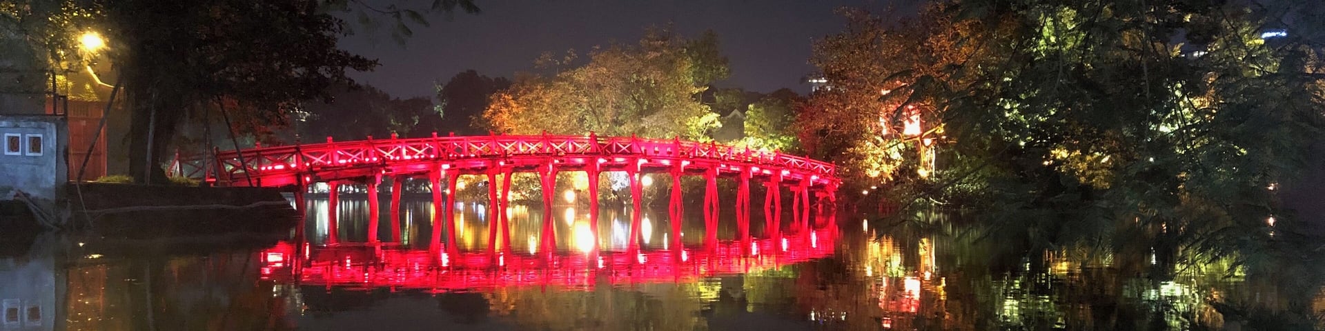 Nice reflection of the lighted up bridge with the moon behind
