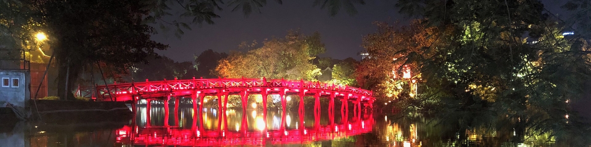 Nice reflection of the lighted up bridge with the moon behind