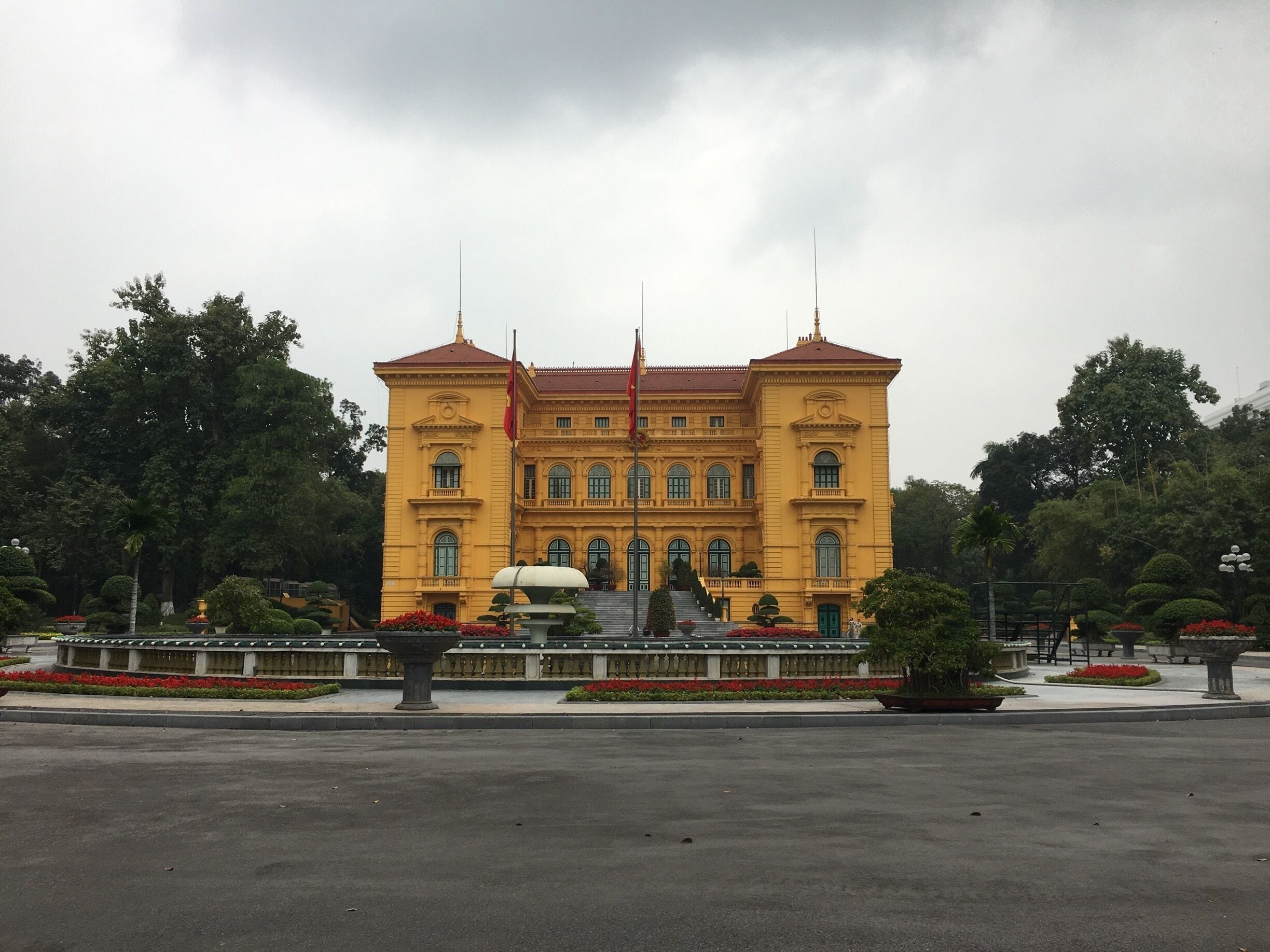Hidden behind this building is the wooden Ho Chin Minh house