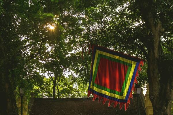 A man rests on the steps that lead to a small pagoda located inside Hanoi's Botanical Garden.