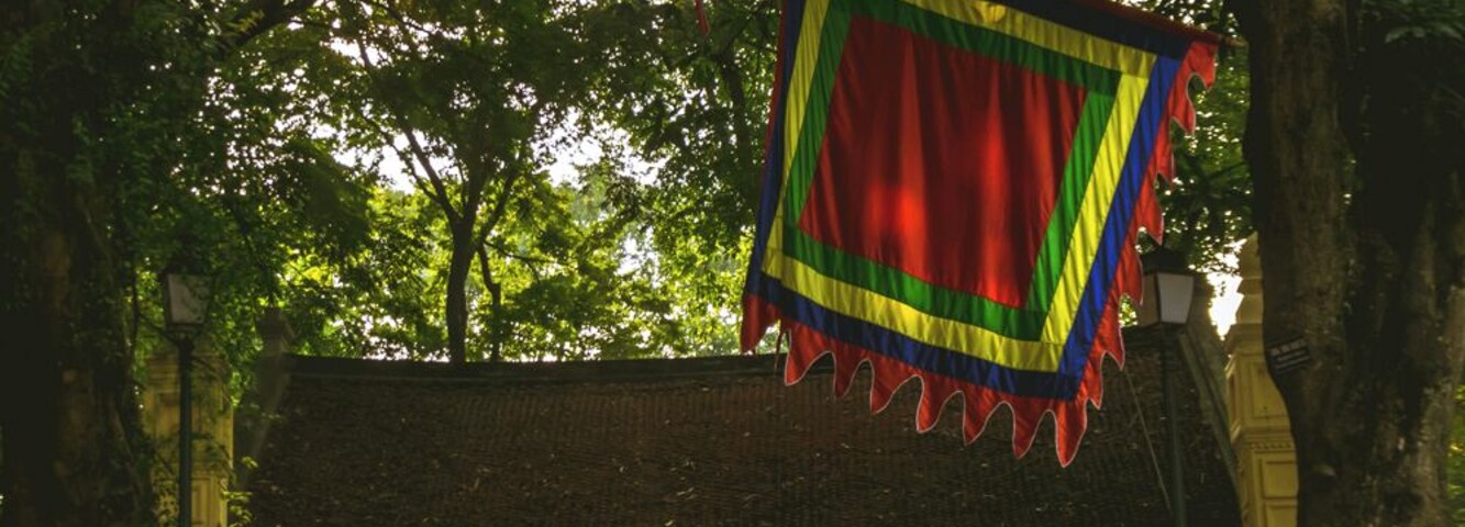 A man rests on the steps that lead to a small pagoda located inside Hanoi's Botanical Garden.