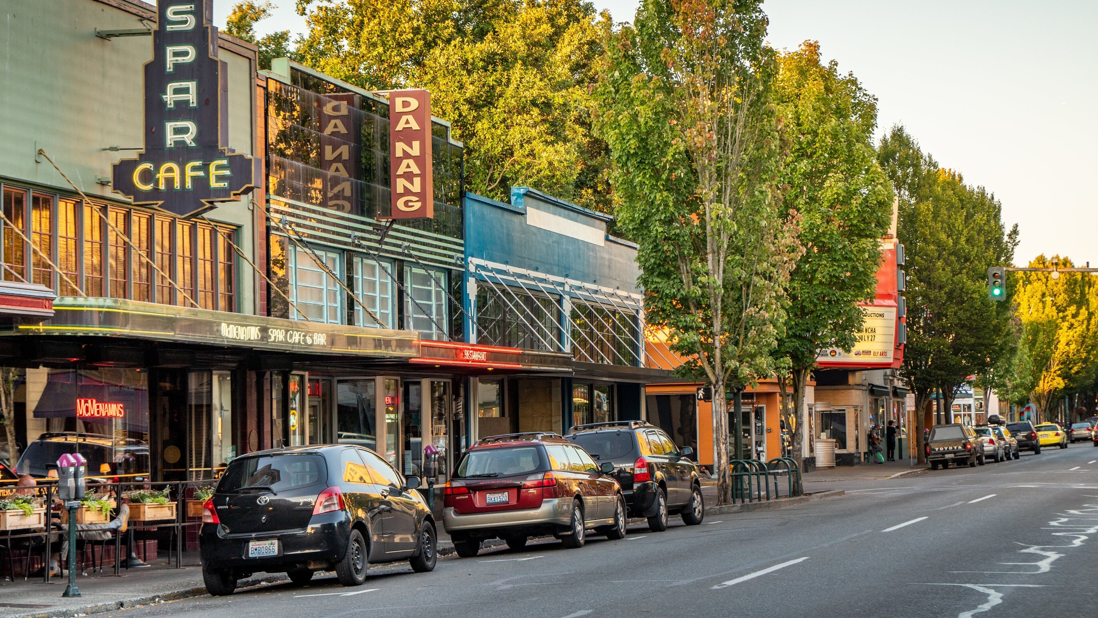 A street lined with vintage buildings, including a cafe and a restaurant.
