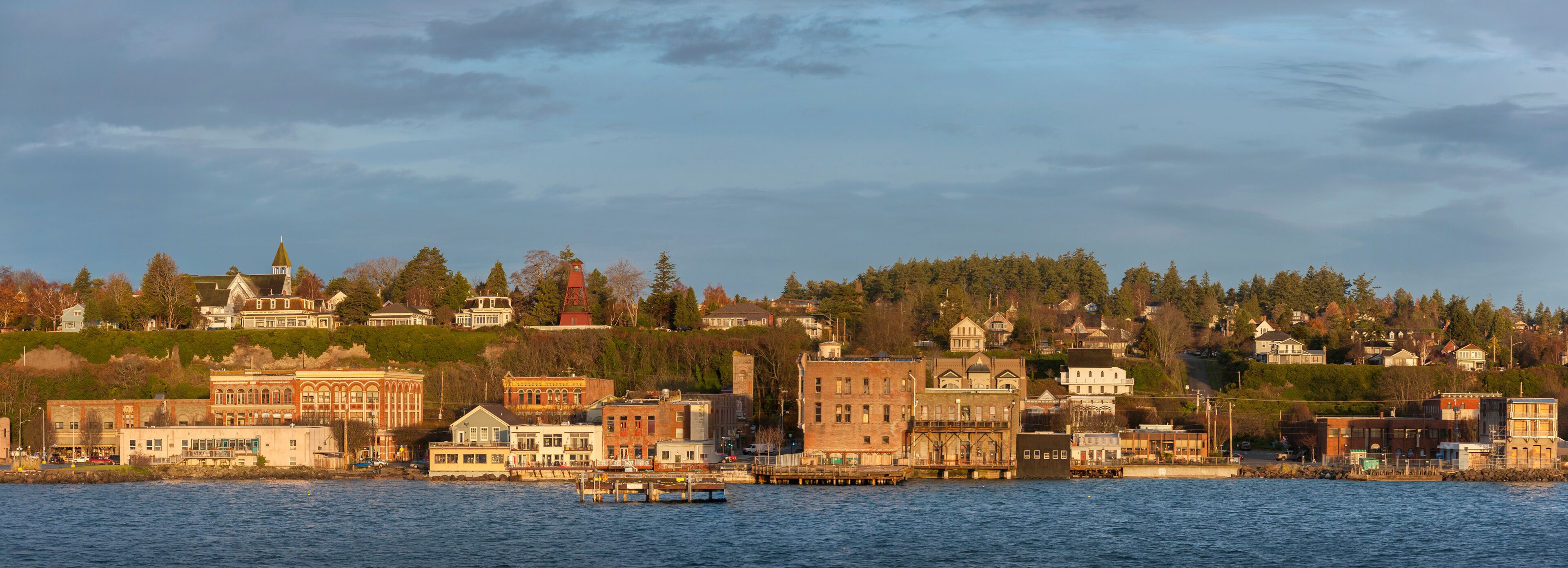 A waterfront cityscape with historic buildings and a dock.