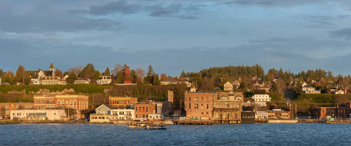 A waterfront cityscape with historic buildings and a dock.