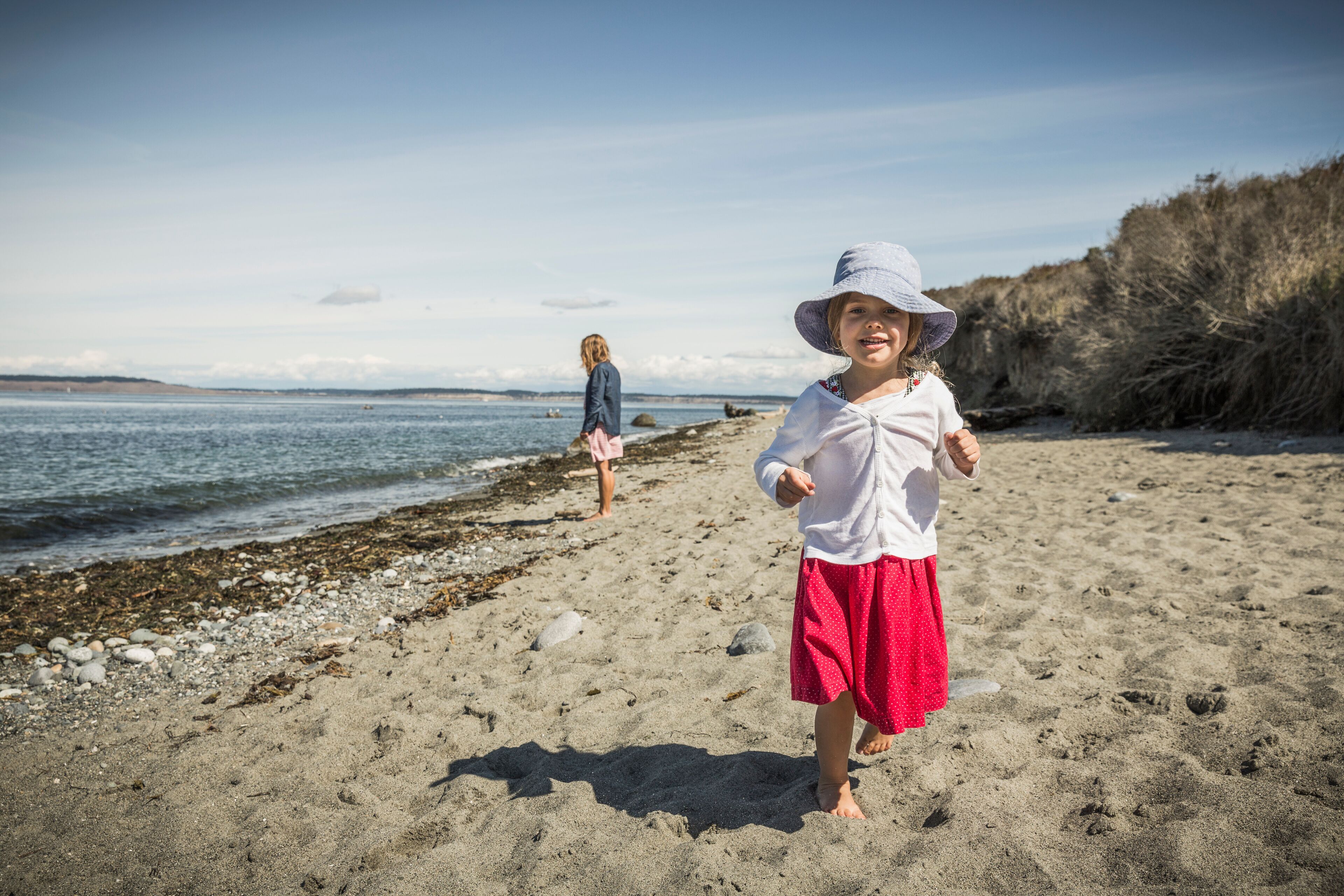 Cute girl in sunhat on beach, portrait, Port Townsend, Washington, USA