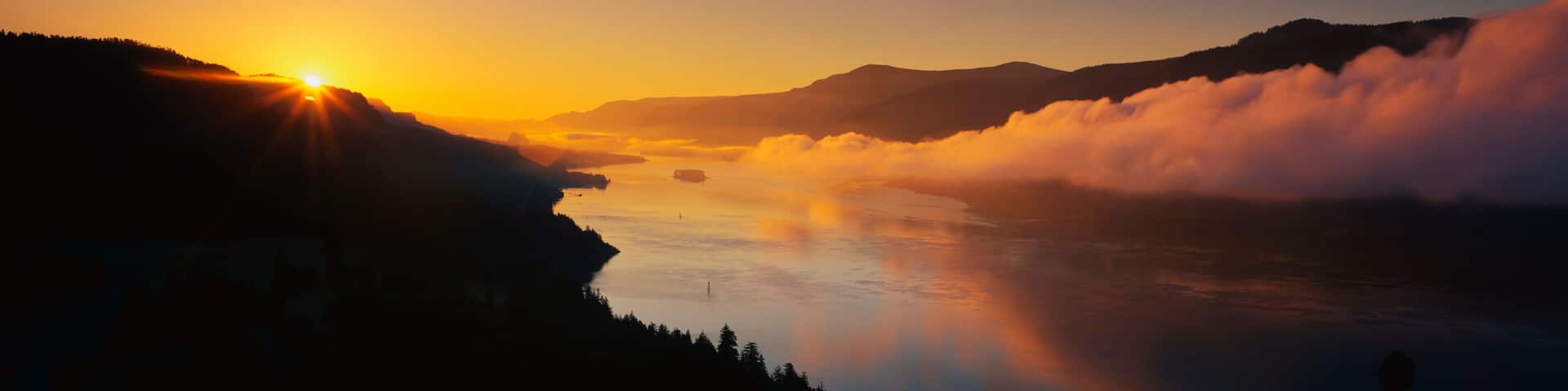 This is Cape Horn on the Columbia River Gorge at sunrise. There is a morning mist over the river.