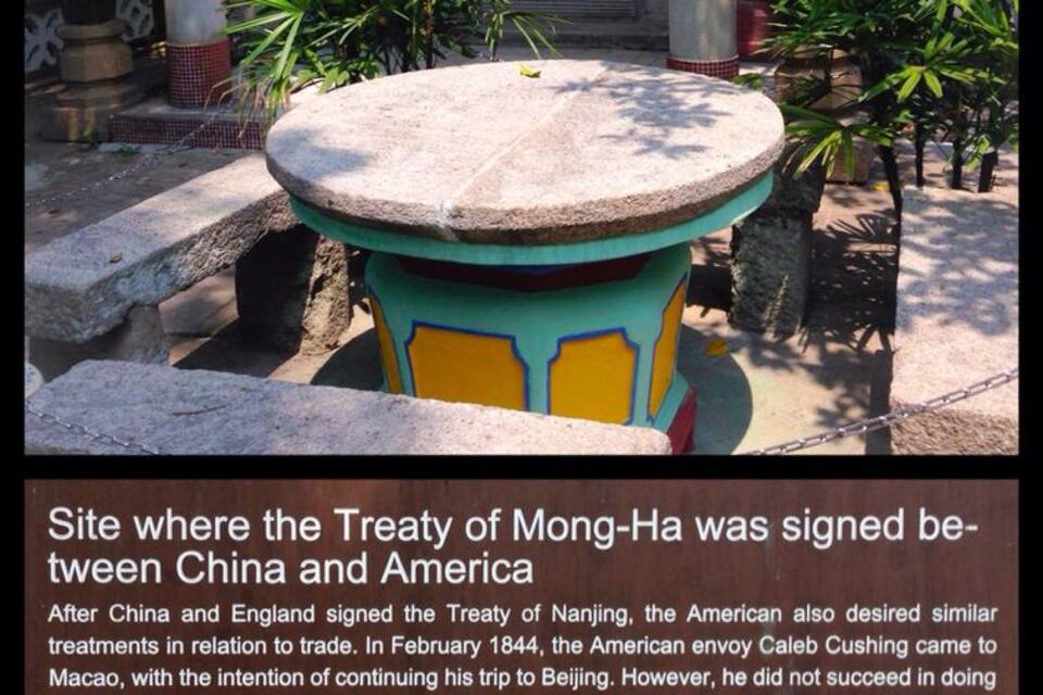 A stone table and stools at a historical site where the Treaty of Mong-Ha was signed between China and America.