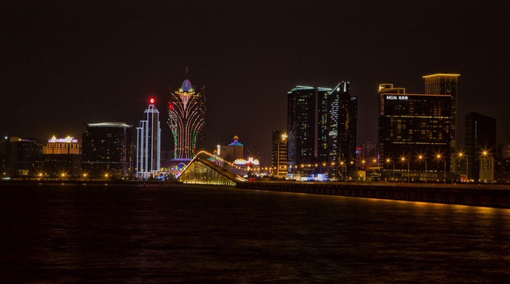 A view of the Macau Skyline from Taipa Island. In the center angling to the right is the Macau Taipa Bridge, the buildings in view from left to right are - Grand Emperor Hotel, Lakeview mansion residences. BOC Tower, Grand Lisboa Hotel, Lisboa Hotel, Wynn, One Central and Mandarin Oriental, and MGM.