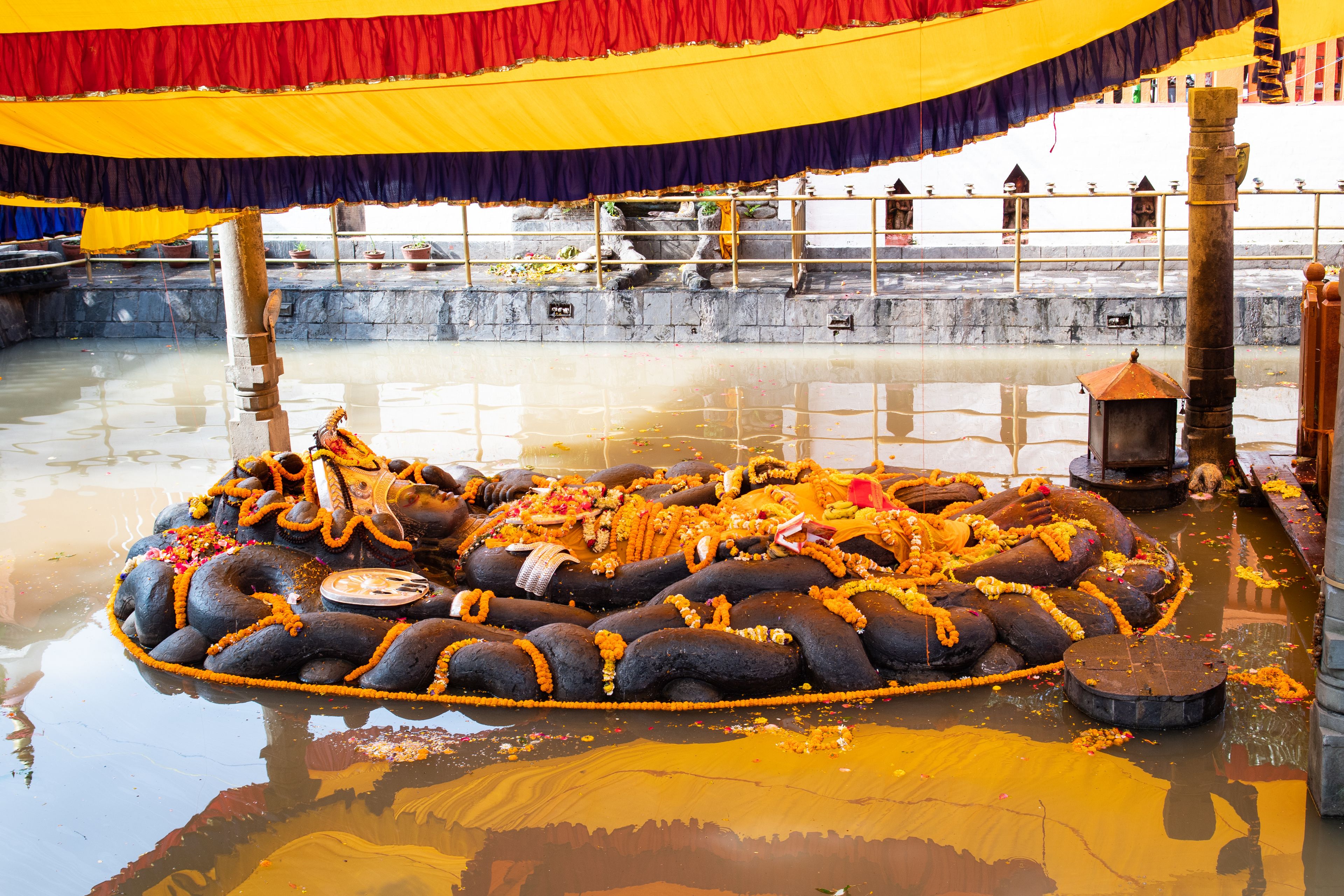 Lord Vishnu Statue in the water at Budhanilkantha Temple. The temple is located in Budhanilkantha near Kathmandu in Nepal. It is dedicated to Lord Vishnu and situated below the Shivapuri Hill.