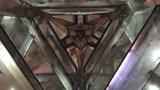 Fish tanks going all the way up several floors. The photo was taken from below looking up.