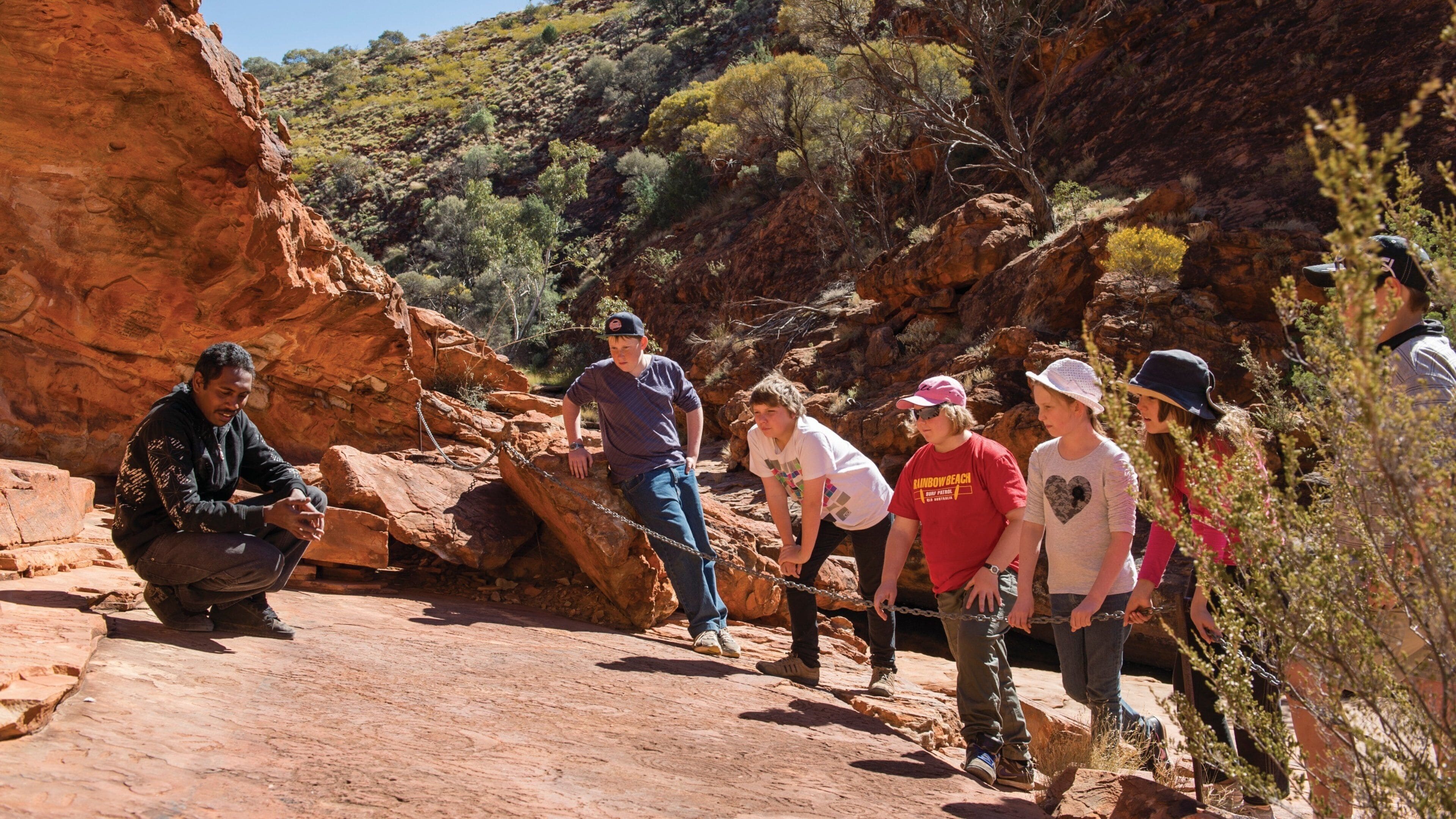 Uluru featuring desert views as well as children