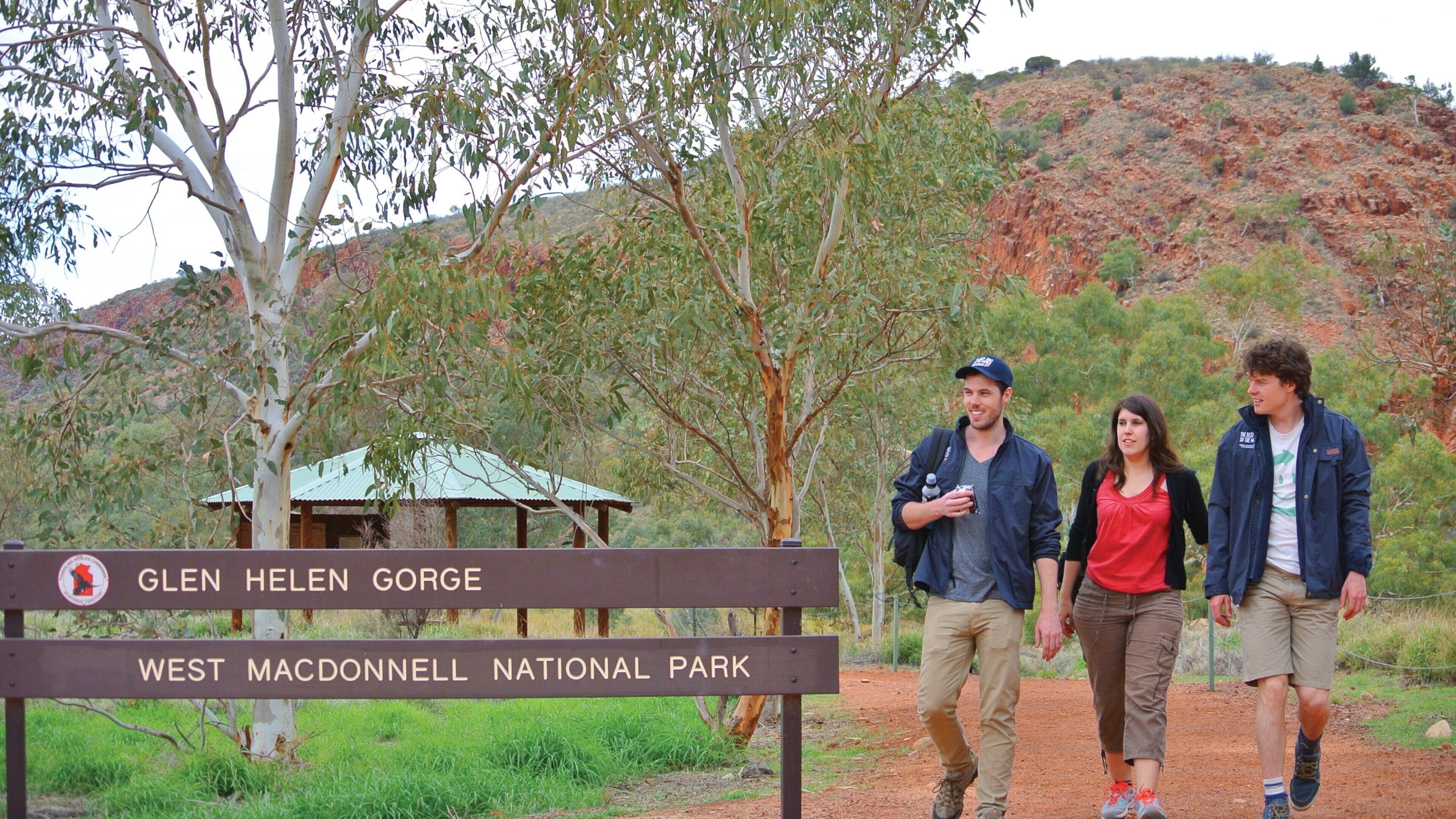 Uluru which includes tranquil scenes as well as a small group of people