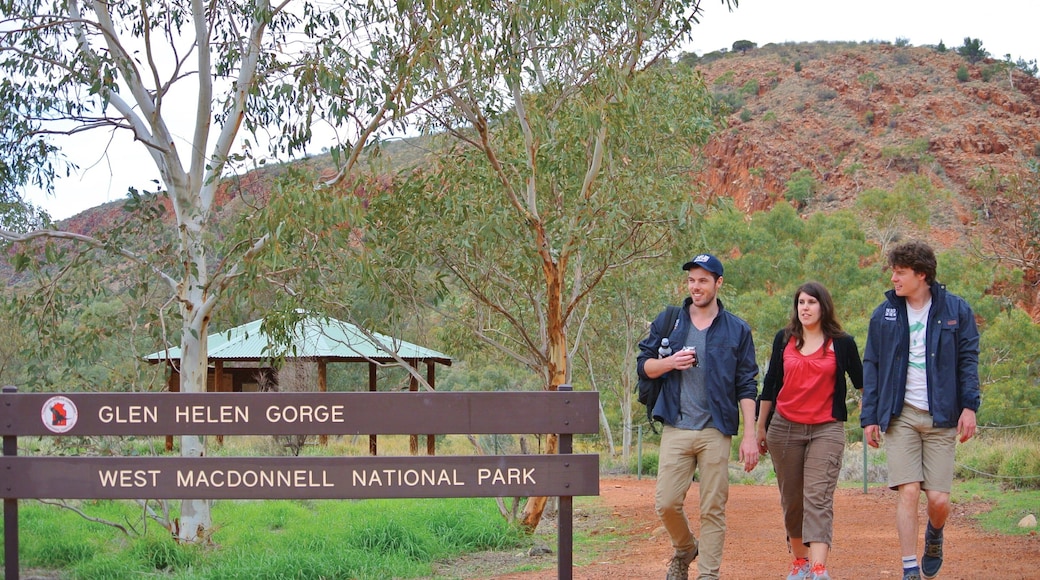 Uluru which includes tranquil scenes as well as a small group of people
