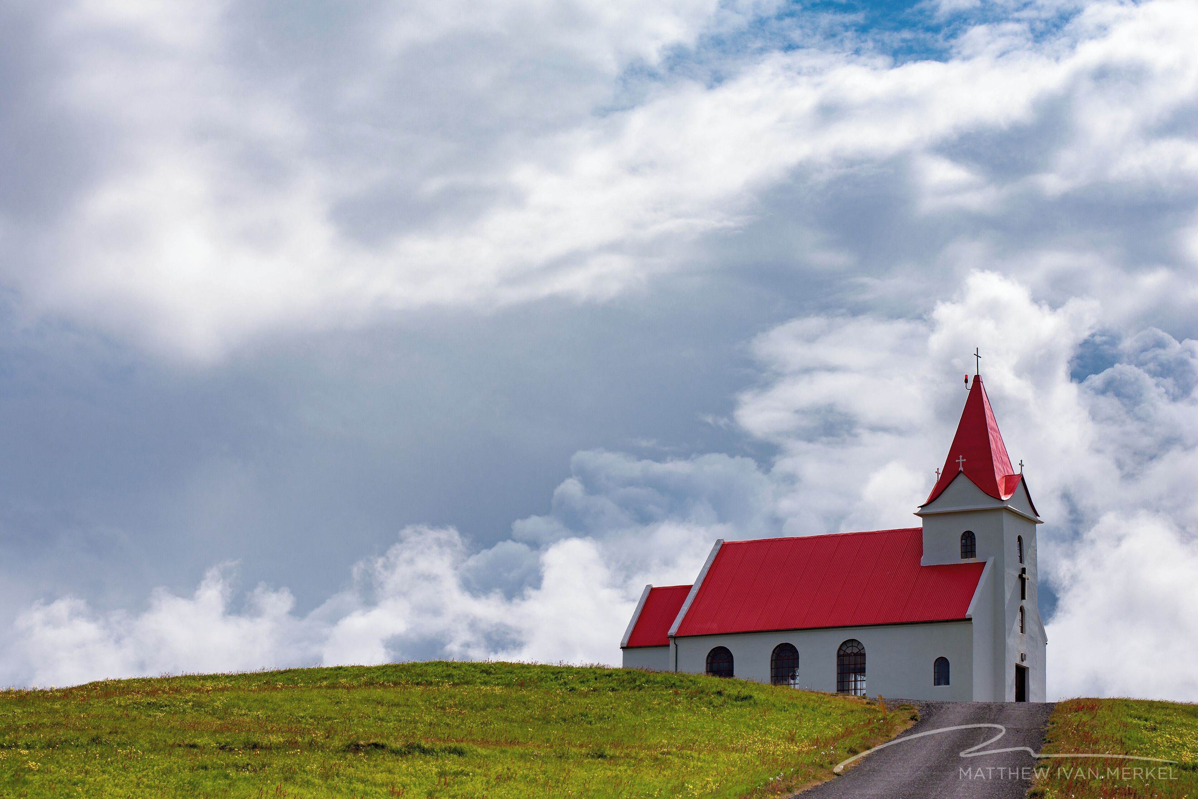 Classic red-roofed church on a hill.