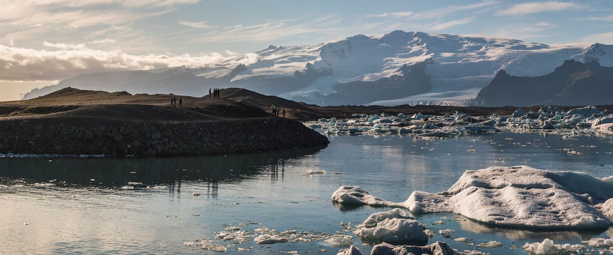 Icebergs in Jokulsarlon Glacier Lagoon, melting due to global warming and climate change, Vatnajokull Ice Cap behind, South East Iceland, Europe