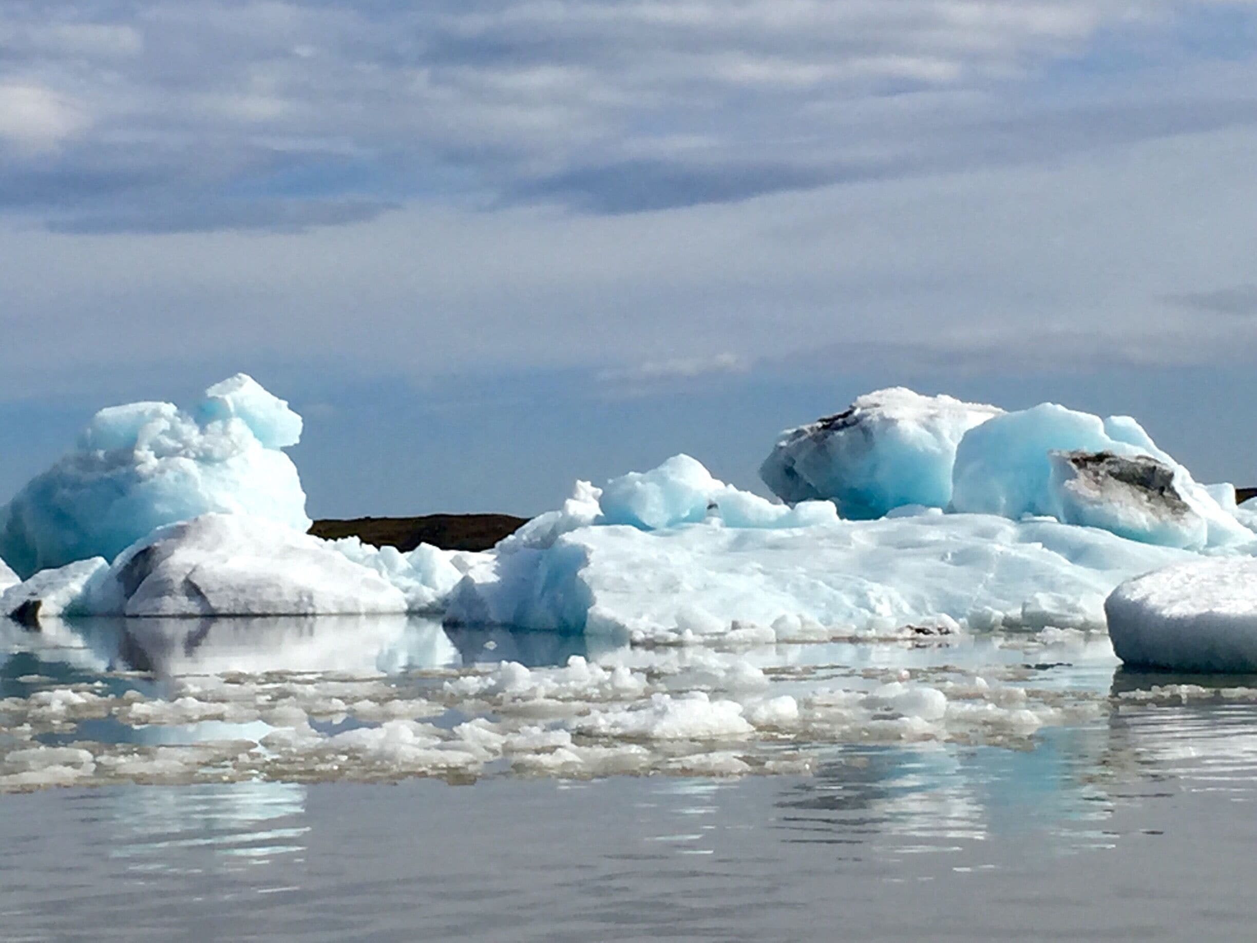 The smaller of the two lagoons. I saw this one first and it was amazing. It was off to feel like your driving in the middle of no where and then, boom, amazing glacier lagoon! Lol. I couldn't decide which boat tour to do so I chose to do both (at each lagoon). For the tour I actually liked this one better. Cozier, the guide seemed more knowledgeable, and the mountain backdrop was better. Definitely go hang out at the other lagoon on the beach, but I'd vote do the tour at this lagoon. 
Love the reflections!!! This was approx 3pm in June. 
O and I don't recommend if you want to try both tours to do them back to back. The lagoons are only 10km/10min from each other, but this tour went over for me so I missed the other one and had to reschedule it for the morning. Good thing I was staying nearby. 

#blue