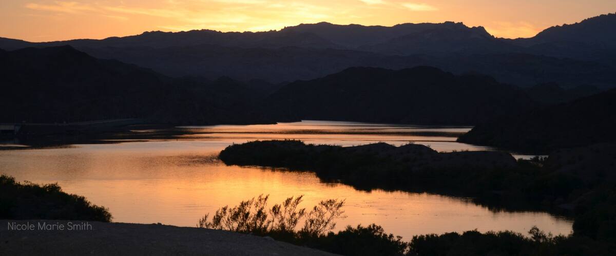 Bullhead City showing a hot spring, a sunset and mountains