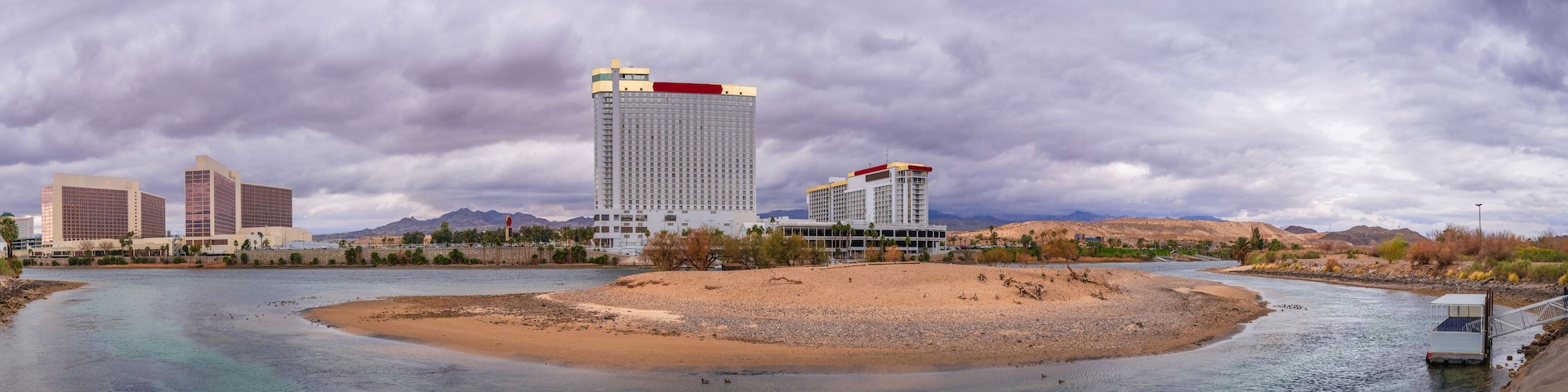 Colorado River Landscape Series, Laughlin skyline and buildings with dramatic stormy cloudscape over the curving river and sand island of a wildlife sanctuary in Laughlin, Nevada, USA