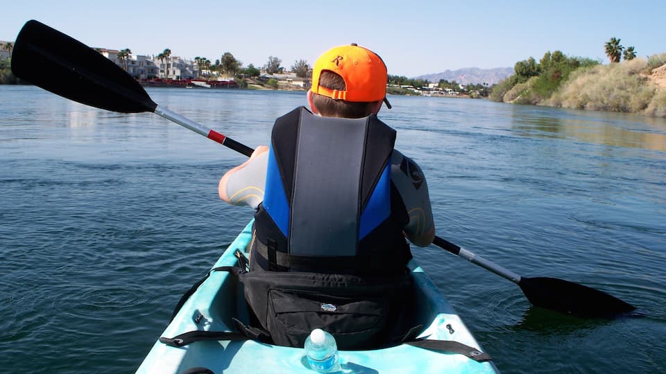 Bullhead City featuring a river or creek and kayaking or canoeing as well as an individual child