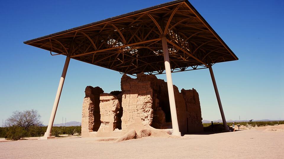 A historical stone structure with a metal roof.