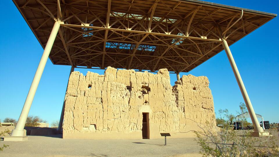 A large, ancient stone structure with a modern metal roof.