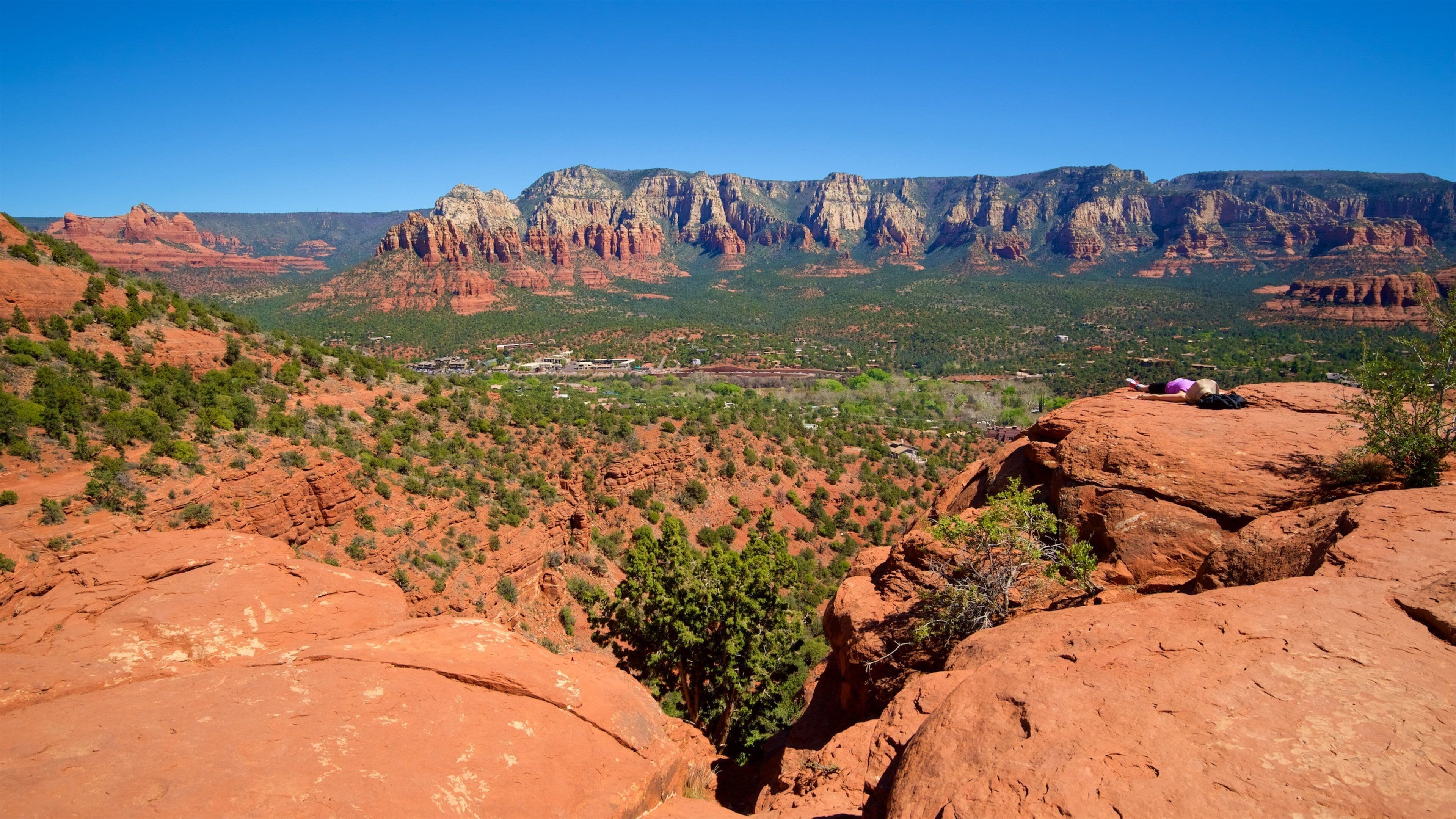 A red rock landscape with a town in the valley.