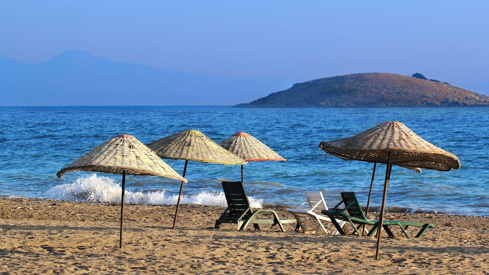 Many straw beach umbrellas at the seashore in Gumuldur, Turkey
