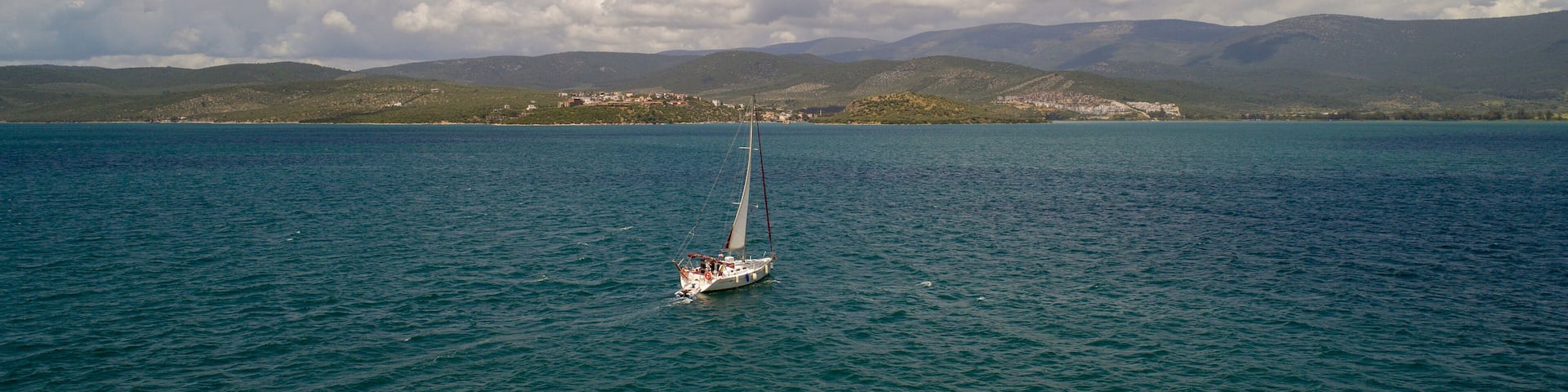 Aerial view of sailboat at sea in Turkey. Aerial view of beautiful green lagoon at hot summer day