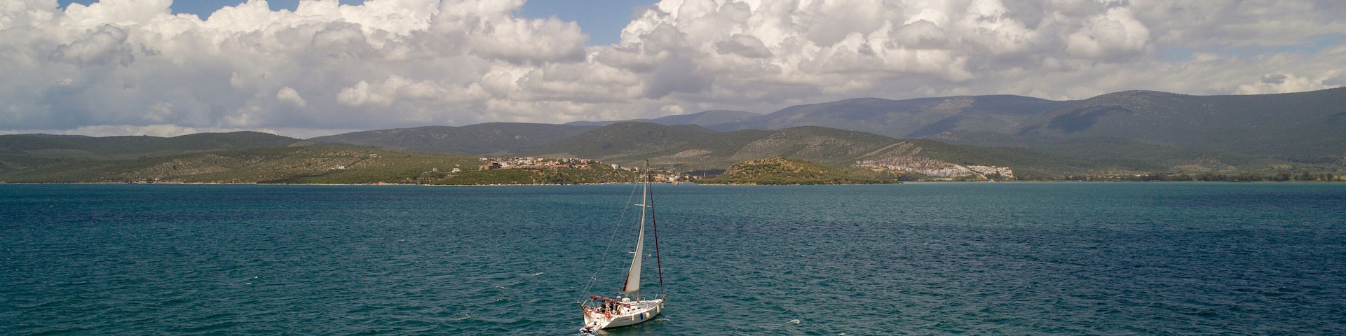 Aerial view of sailboat at sea in Turkey. Aerial view of beautiful green lagoon at hot summer day