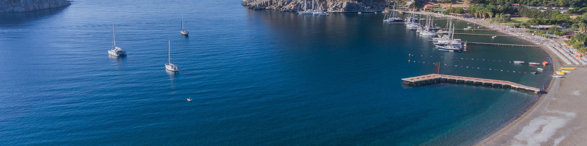 Bending a pebble beach. Resort area in the Bay on the Mediterranean coast of Turkey