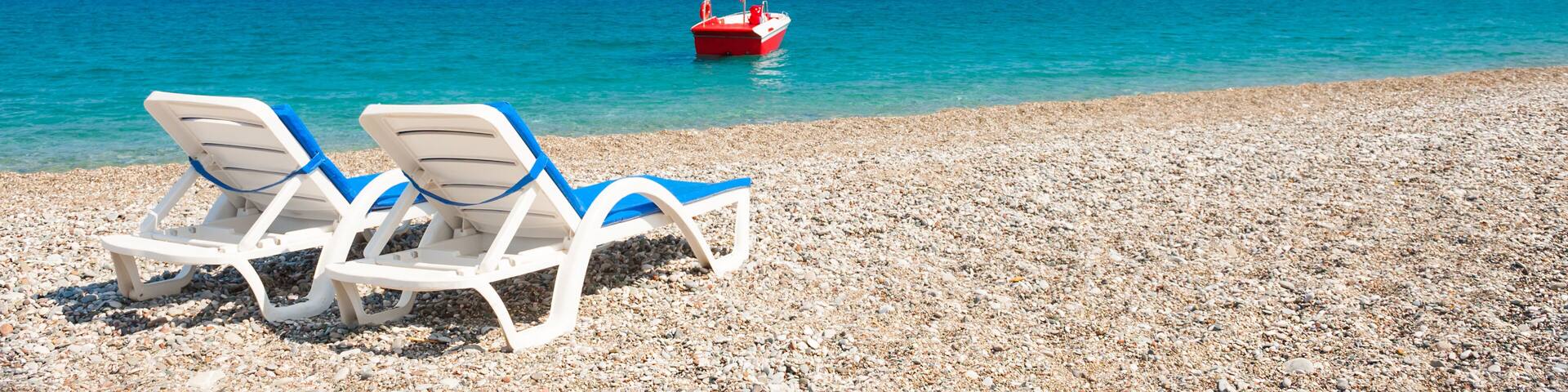 Two chaise lounges on the beach in Kemer, Turkey.