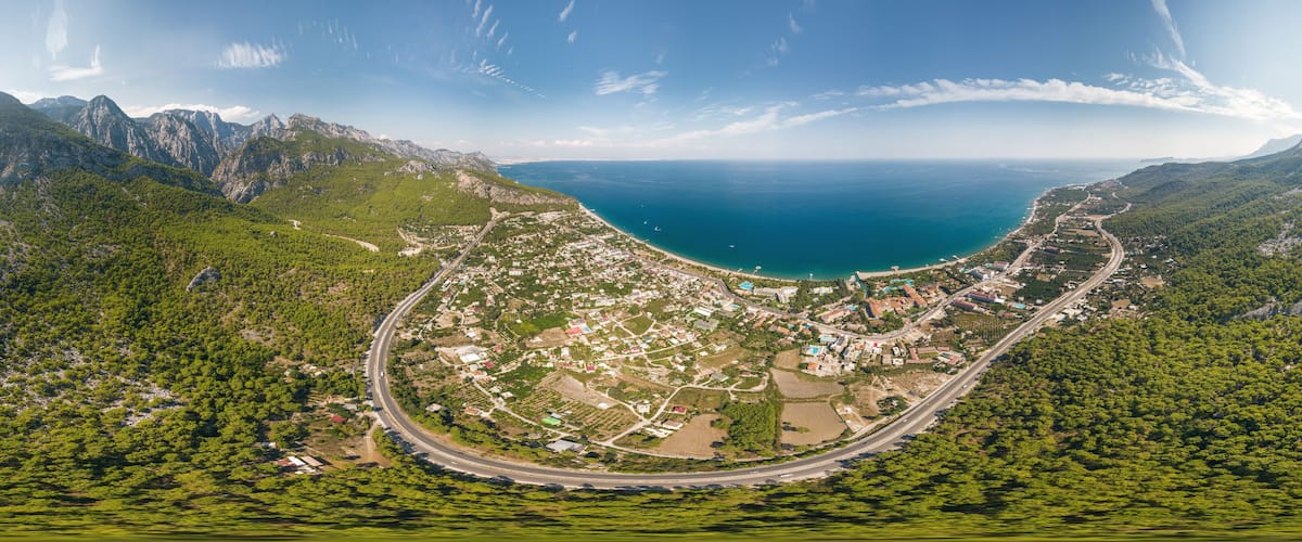 Panorama of the sea and mountain landscape with a serpentine road near the village of Kemer, Turkey. Aerial view