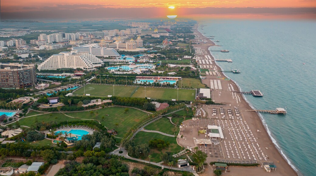 Sandy beaches of the Mediterranean. Kundu - Belek holiday complex with five star hotels. Beach, sea, water sports, parasailing, entertainment and shopping center Aerial view with drone. Antalya-TURKEY