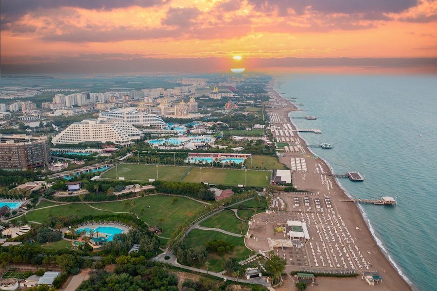 Sandy beaches of the Mediterranean. Kundu - Belek holiday complex with five star hotels. Beach, sea, water sports, parasailing, entertainment and shopping center Aerial view with drone. Antalya-TURKEY