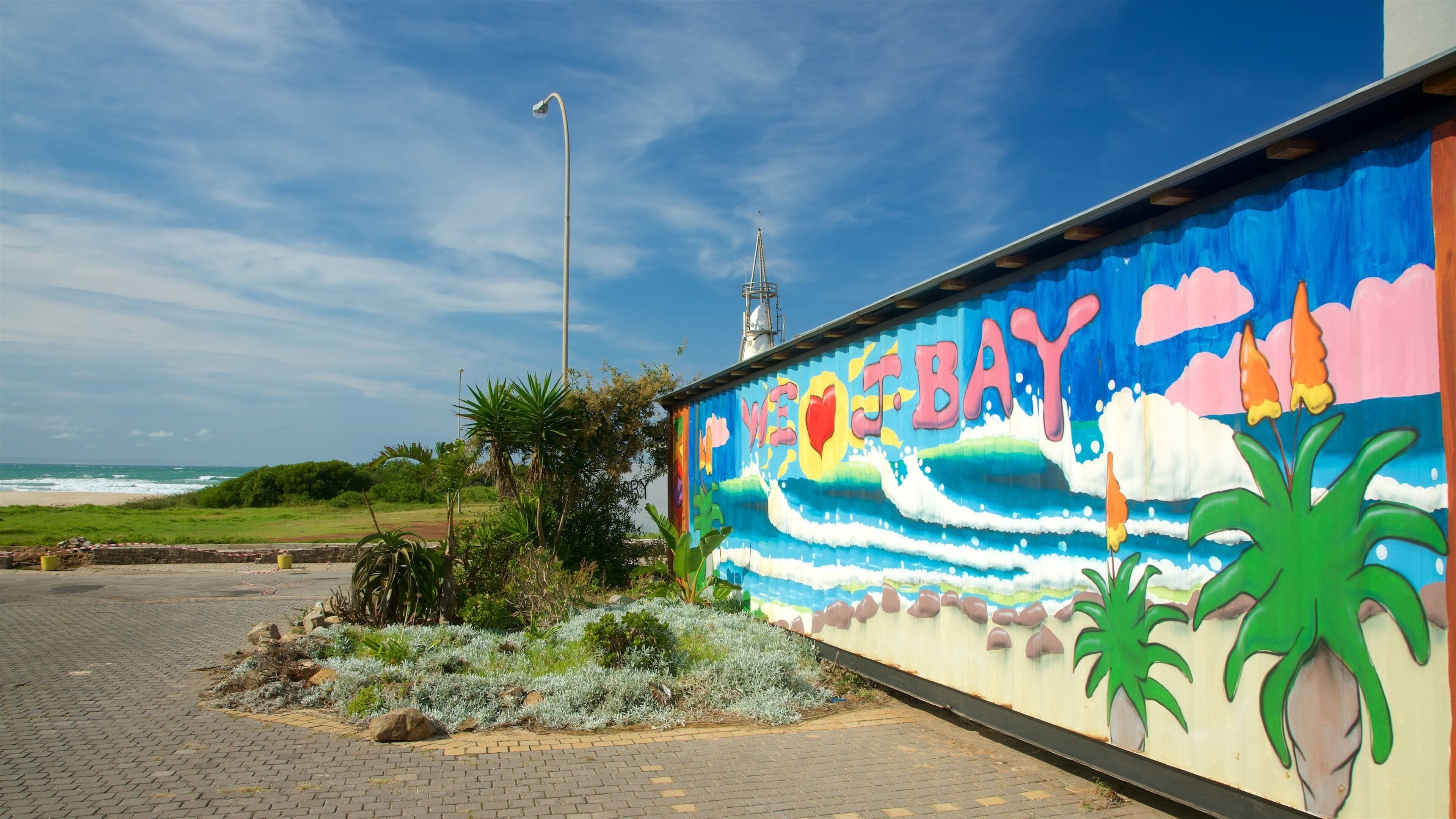 A colorful mural on a wall with the text "VEER BAY" and a lighthouse in the background.