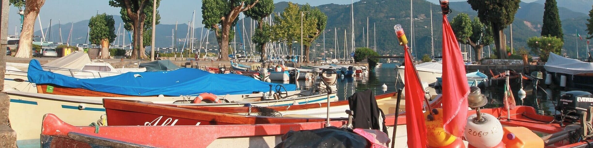 Colourful boats in the port of Portese, Lake Garda, Italy.