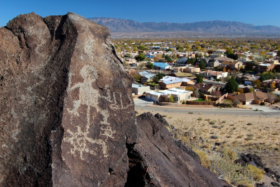 Petroglyphs and nearby housing development at Boca Negra, Petroglyph National Monument, Albuquerque, New Mexico; Shutterstock ID 518553157