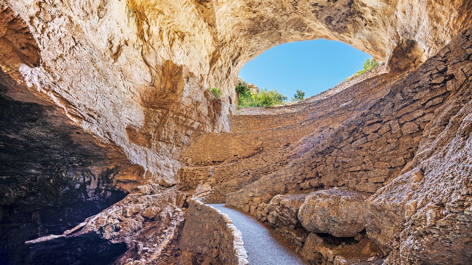 A narrow canyon with a natural archway.