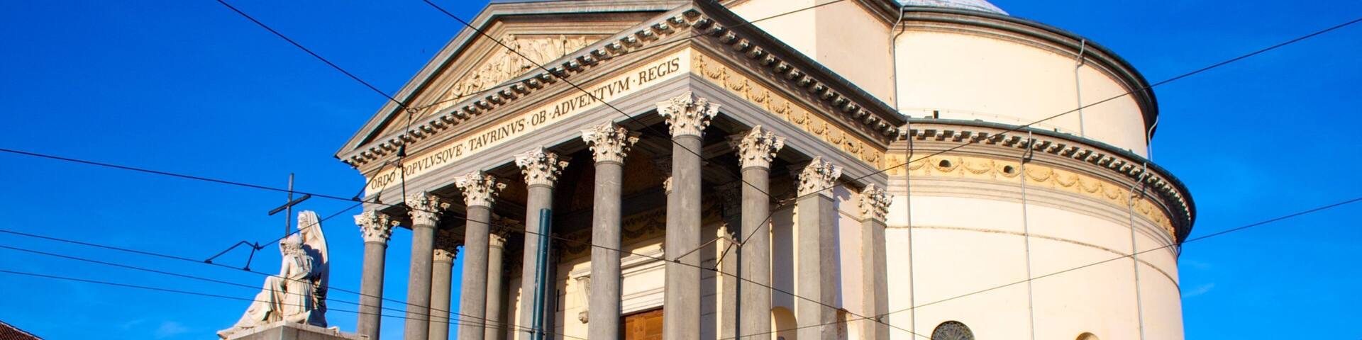 A historic building with classical architecture, including columns and a dome.