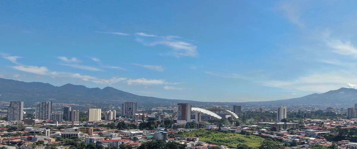 A cityscape with a prominent mountain in the background.