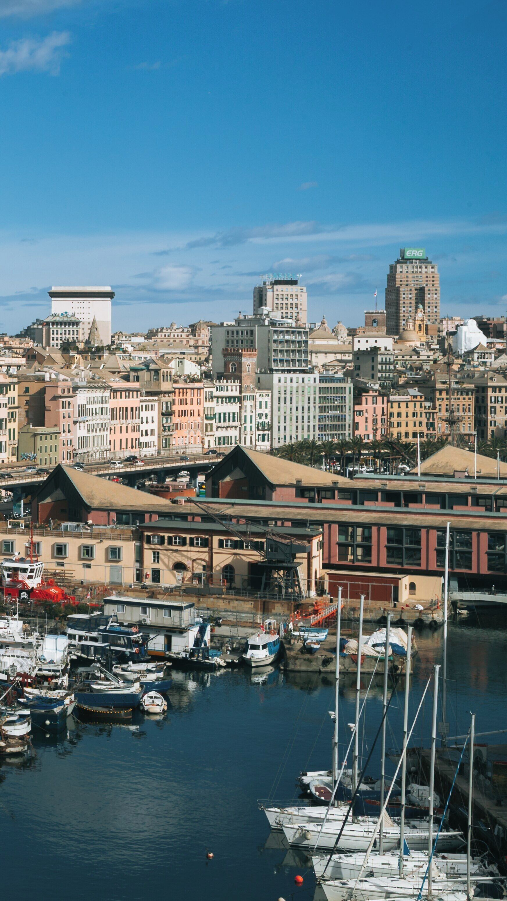 Exploring the historic Galata Maritime Museum and waterfront in Genoa, Liguria, Italy surrounded by city architecture and vessels