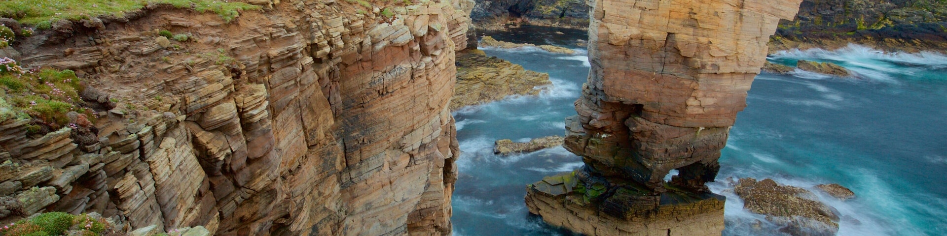 Stromness which includes rugged coastline and tranquil scenes