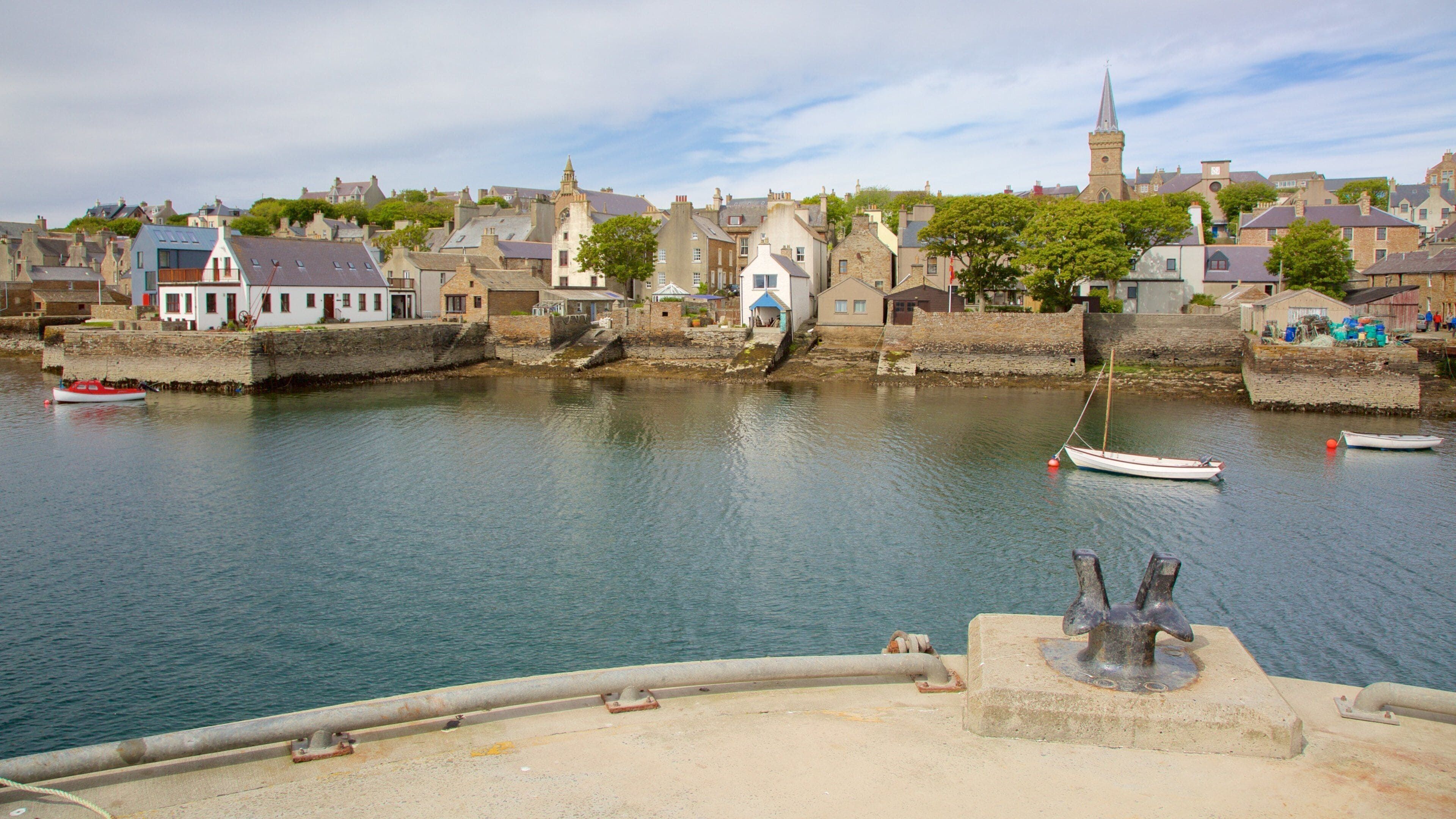 A harbor with boats, a church, and historic buildings.