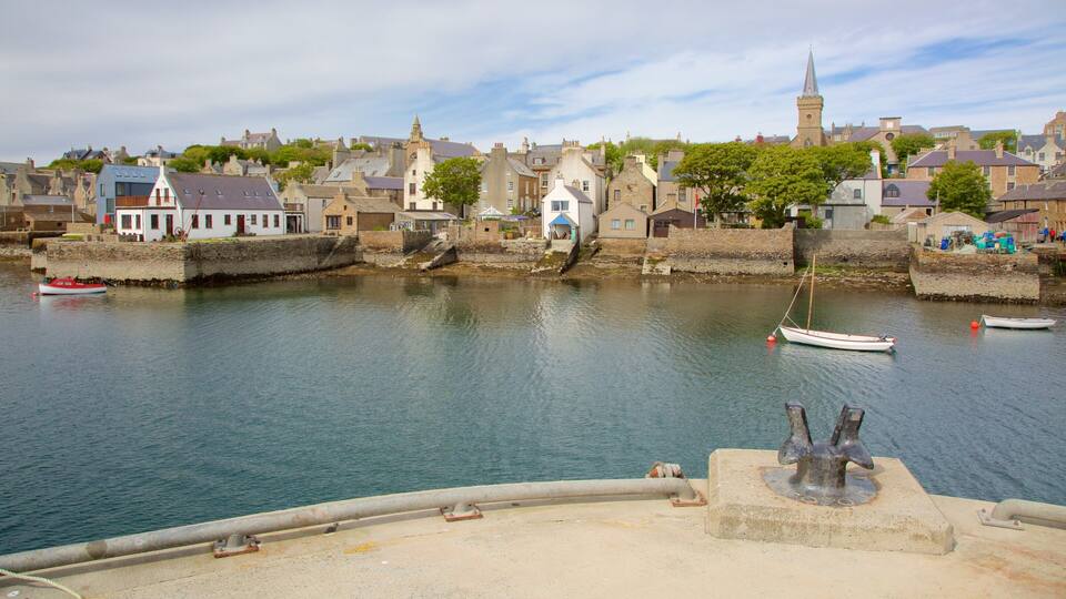 A harbor with boats, a church, and historic buildings.