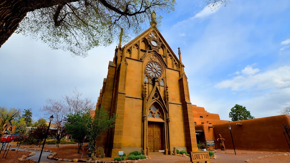 A church with a large rose window and a pointed arch.