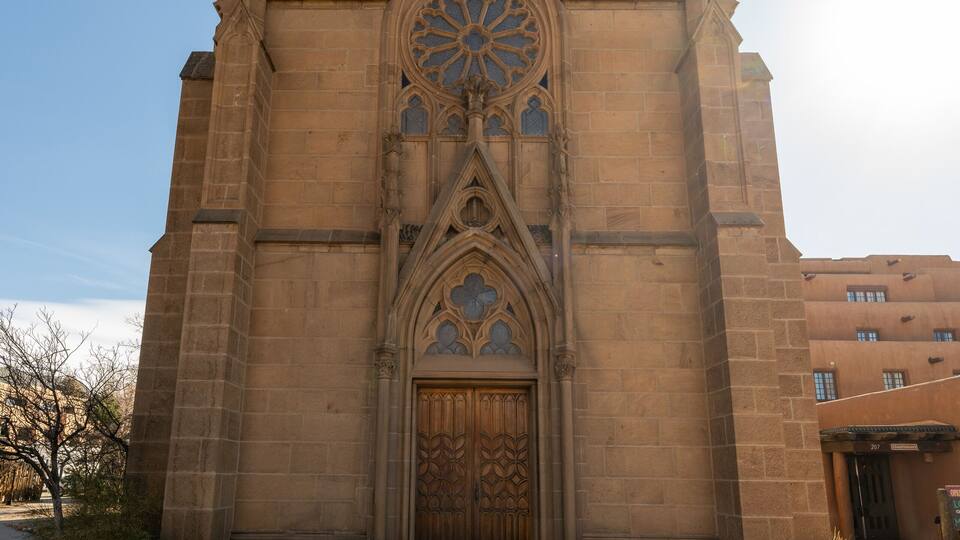 A Gothic-style church with a wooden door and a sign reading "Loretto".